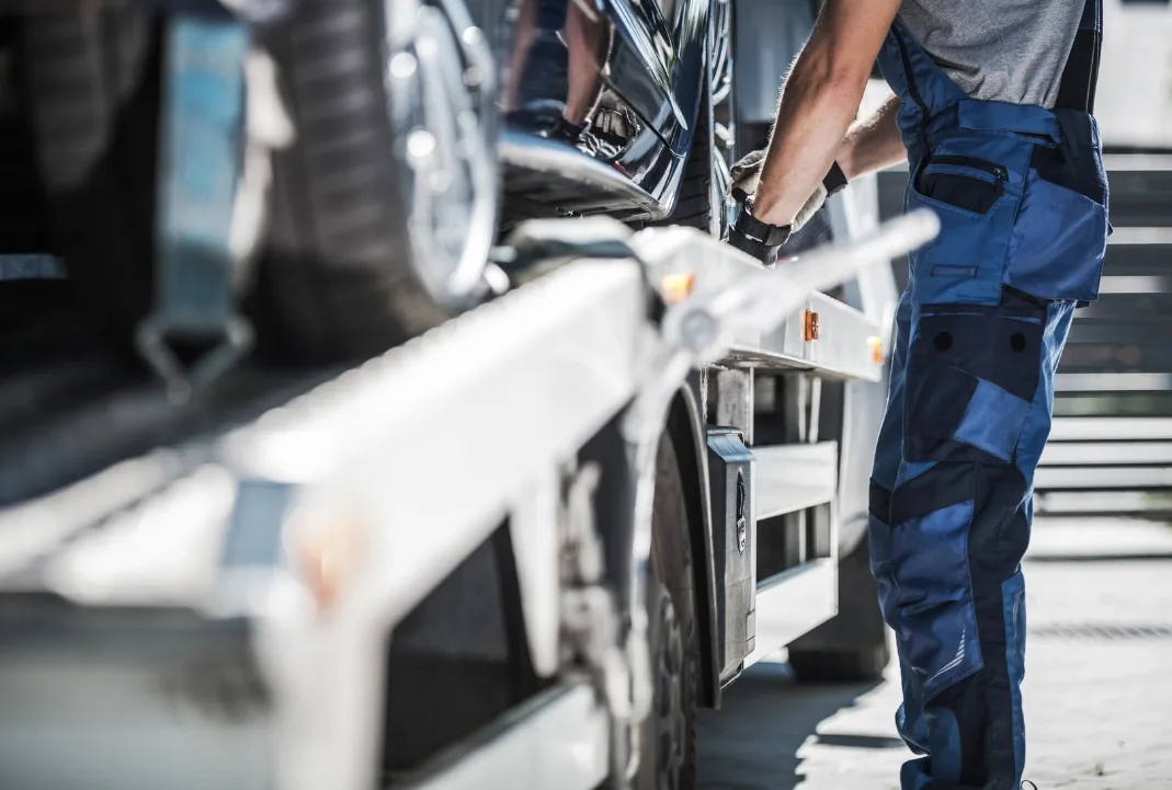 Charlotte tow truck driver loading a car onto a flatbed